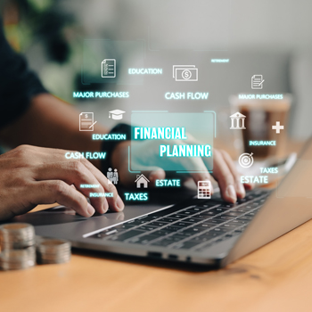 hands on a laptop keyboard with financial related words floating above