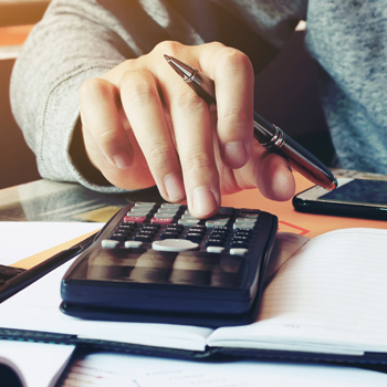close up of a hand using a calculator