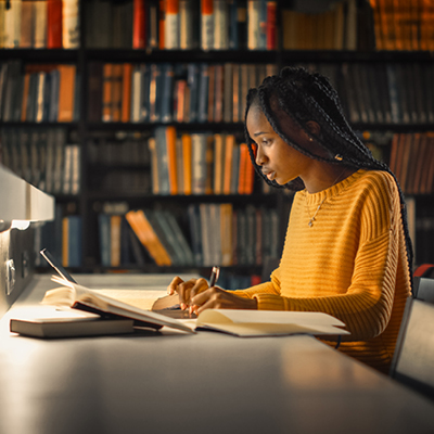 student conducting research in a library