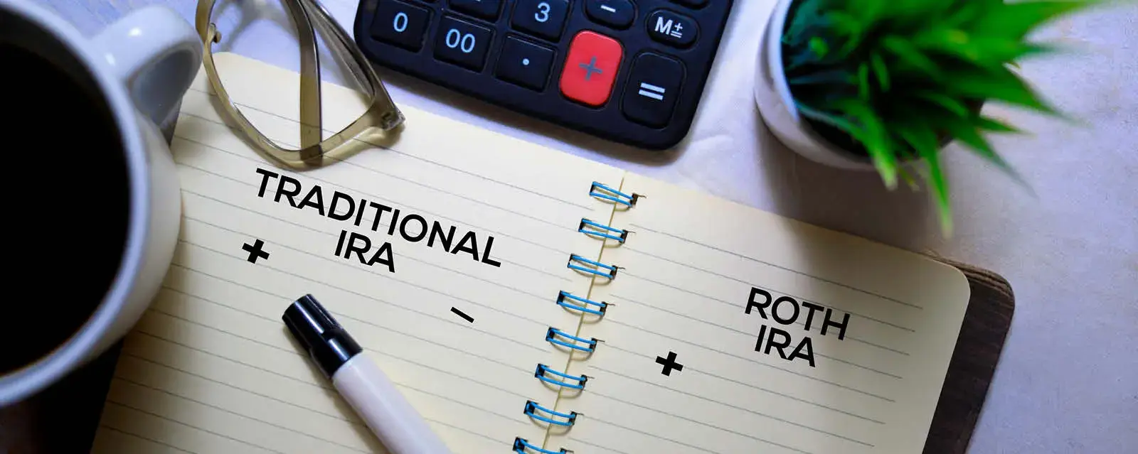 Two pages in a notebook where someone could list the positives and negatives of traditional vs roth iras