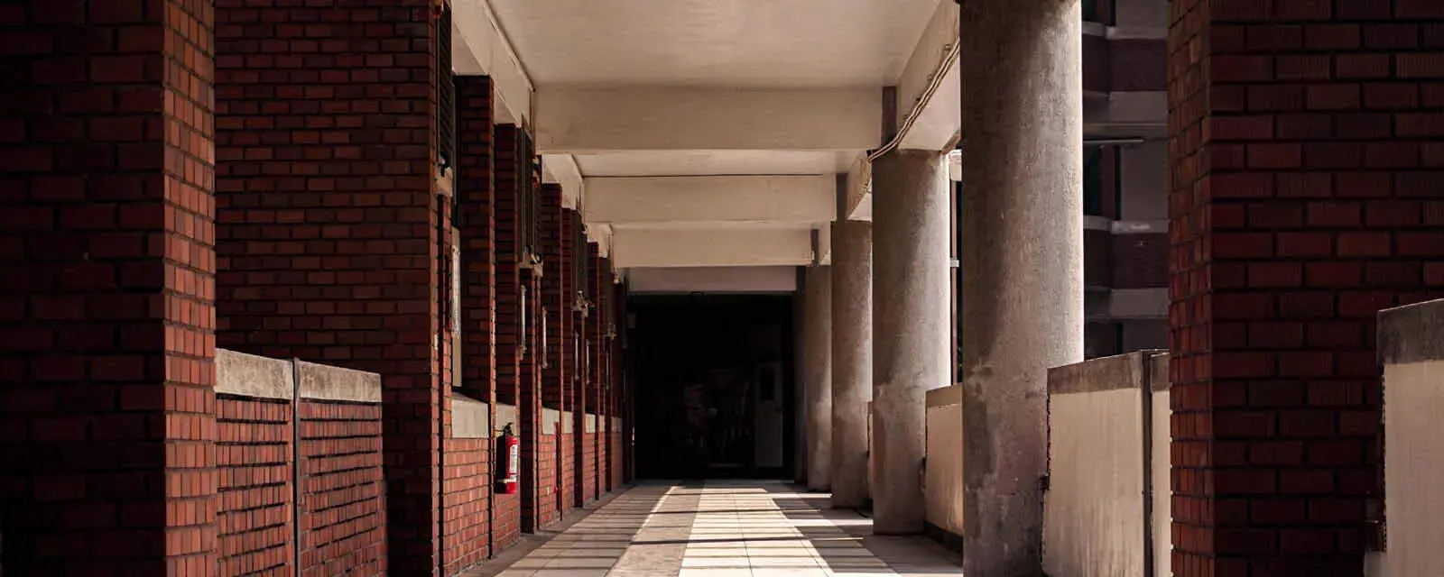 An empty college campus walkway depicting the impact of graduate and professional student loan cuts.