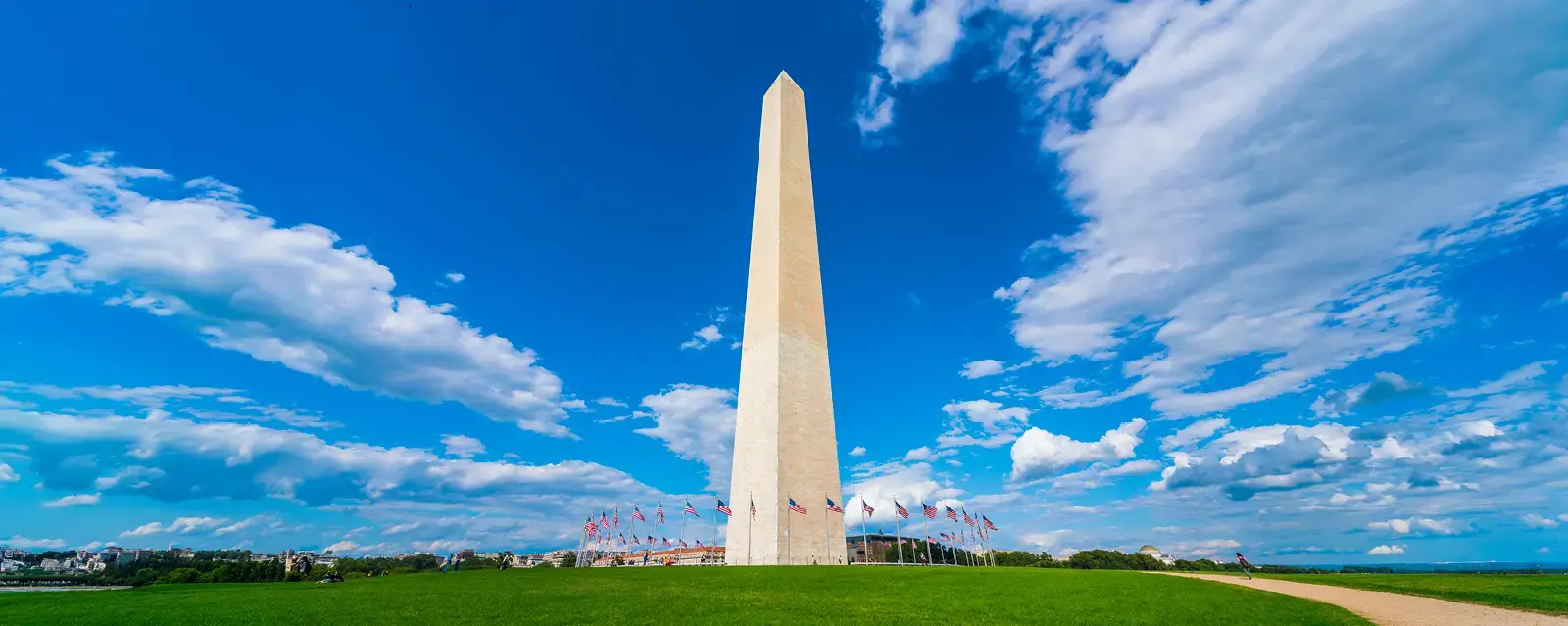 Washington monument on sunny day with blue sky background. 