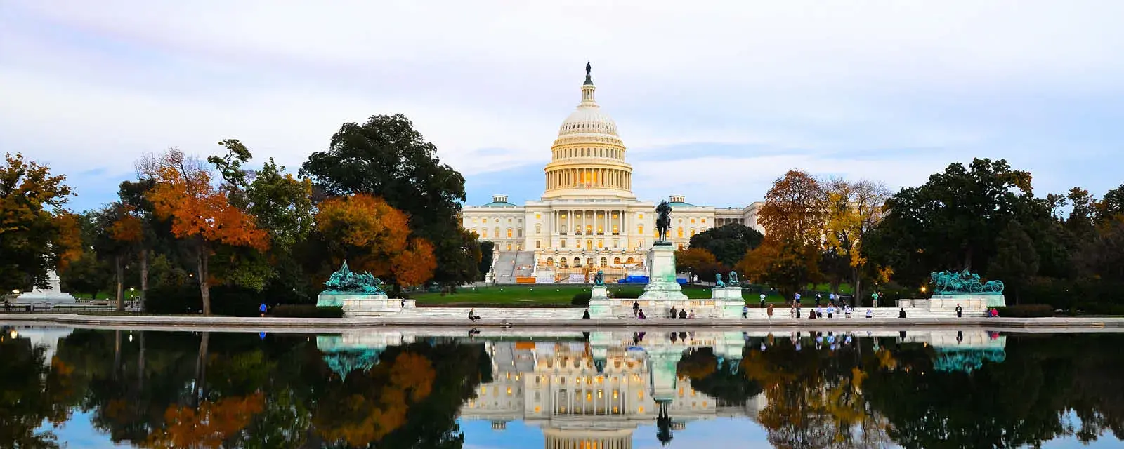 U.S. Capitol Building on an autumn day with trees showing colorful leaves.