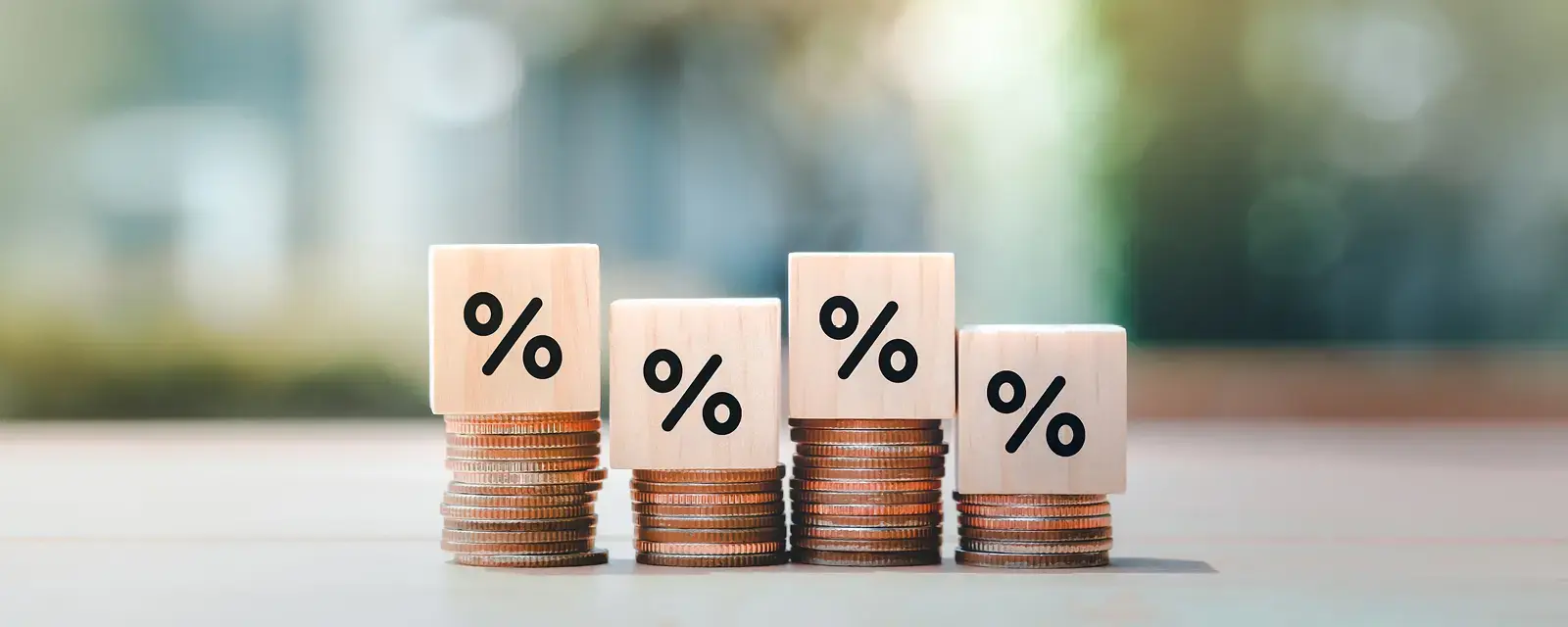 Displayed interest rates and mortgage rates. Wooden block with percentage sign on many level of stack of coin. Illustrating financial growth, interest rate increase, inflation, sale price and tax rise concepts.