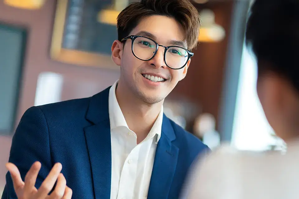 Young male lawyer consulting with female business partner in a cafe setting.