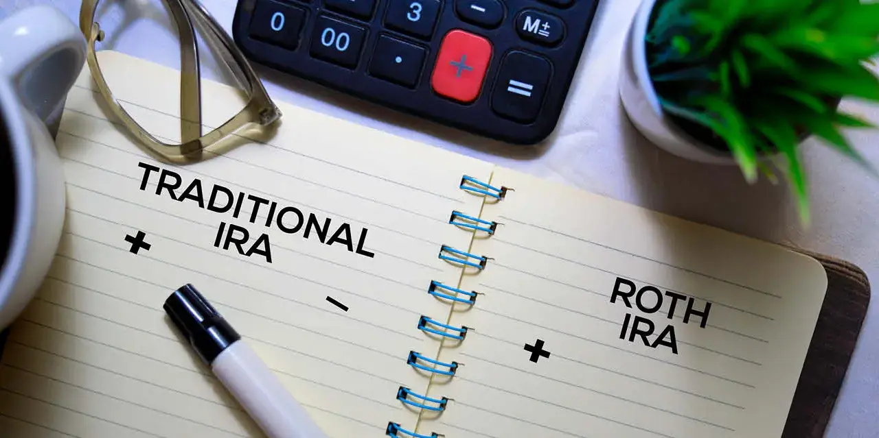 Two pages in a notebook where someone could list the positives and negatives of traditional vs roth iras