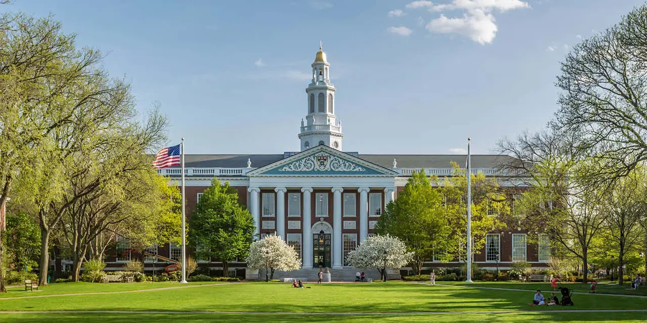 Cambridge, MA, USA September 10, 2017: The historic architecture of Cambridge in Massachusetts, USA showcasing the famous Harvard University Institution with lots of international students and locals passing by.