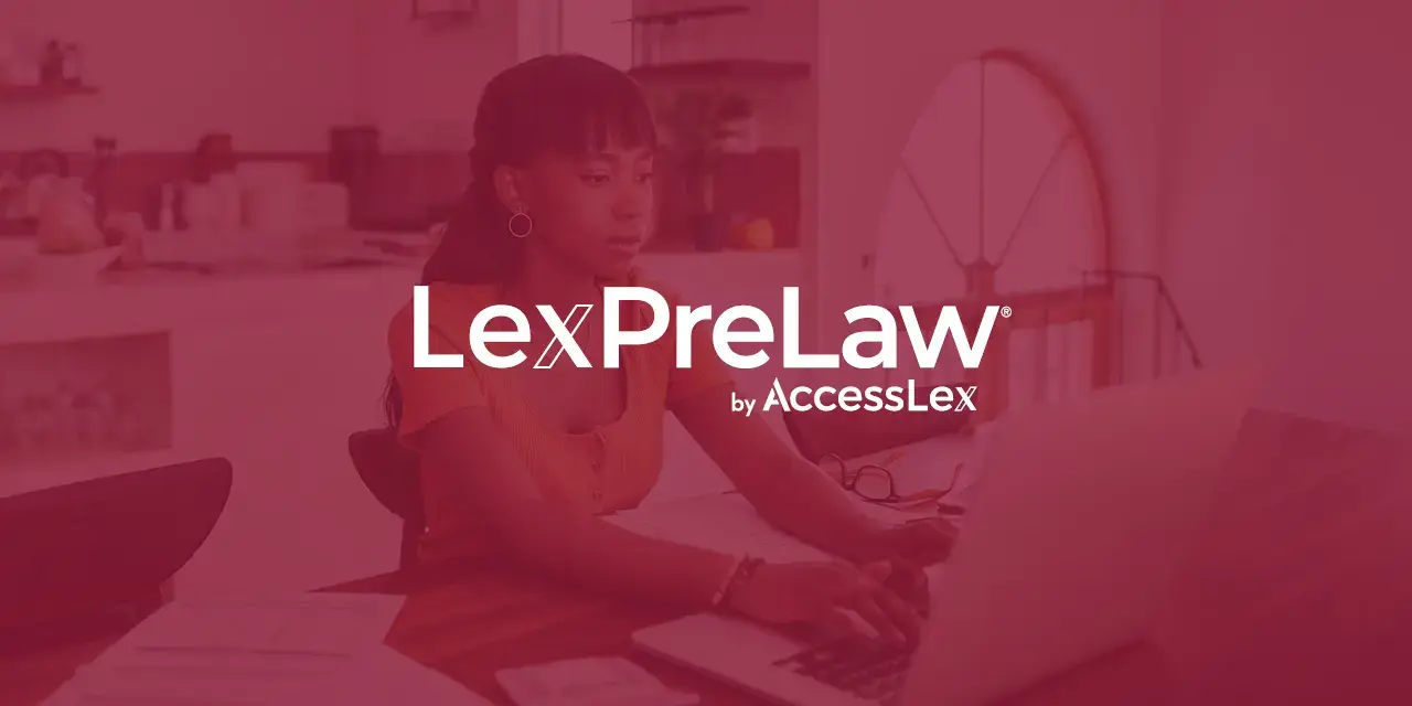 An African American female student sitting at a computer researching the LexPreLaw pathway program. 