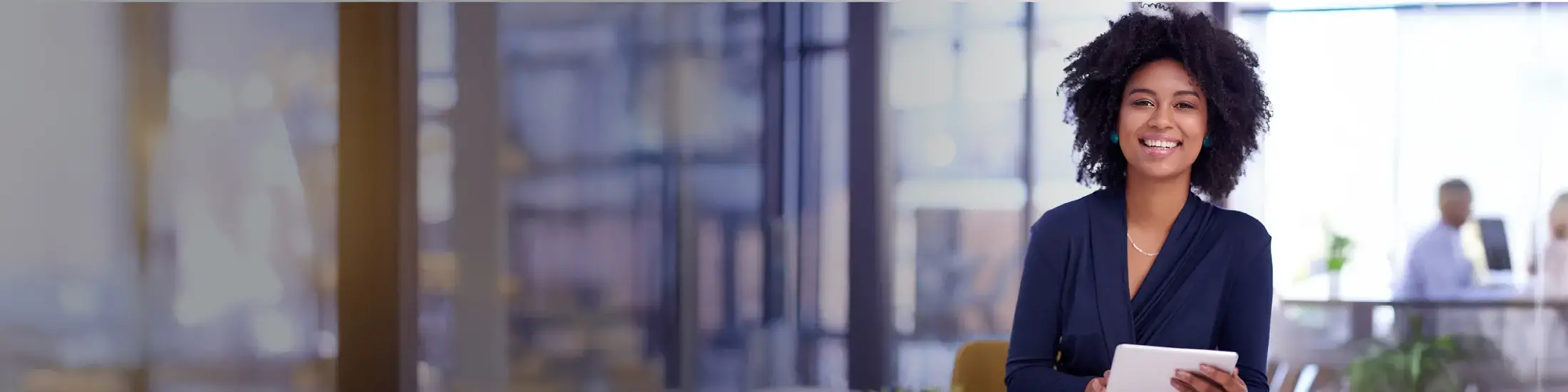 Portrait of a young businesswoman using a digital tablet in an office
