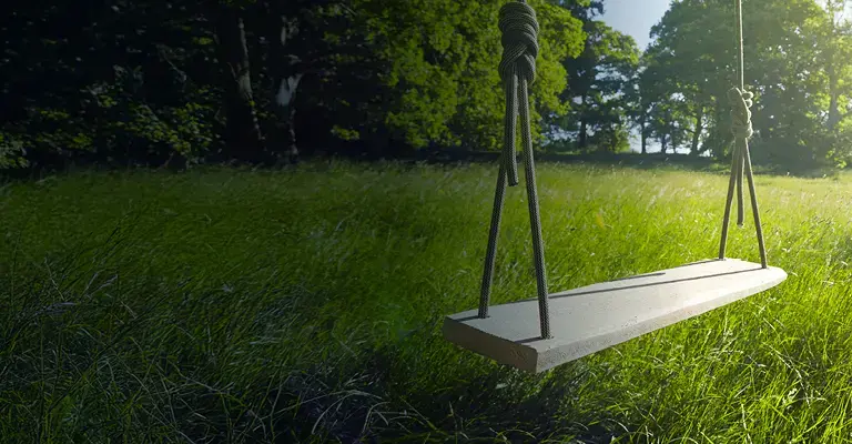 Homemade swing in sunny English countryside.
