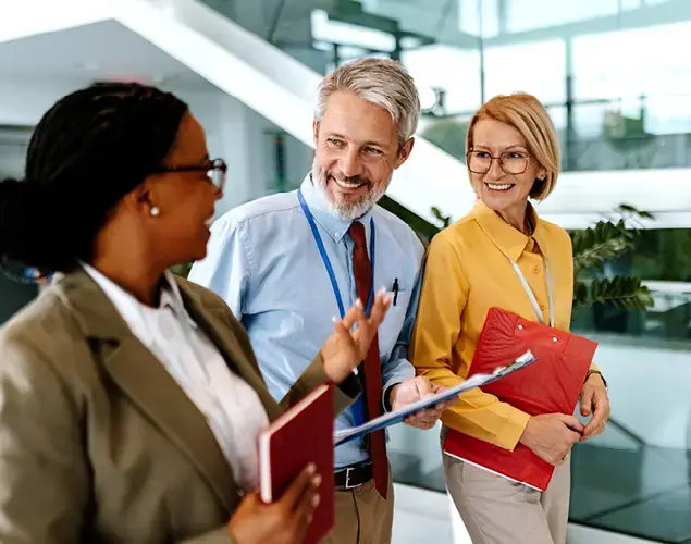 Three law school administrators engaged in discussion