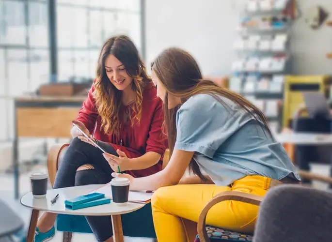Two young professionals collaborating at a table.