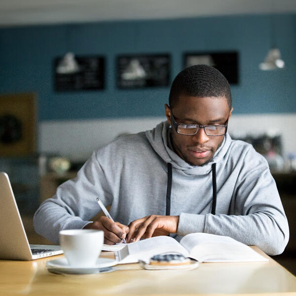 Student sitting at a table taking notes