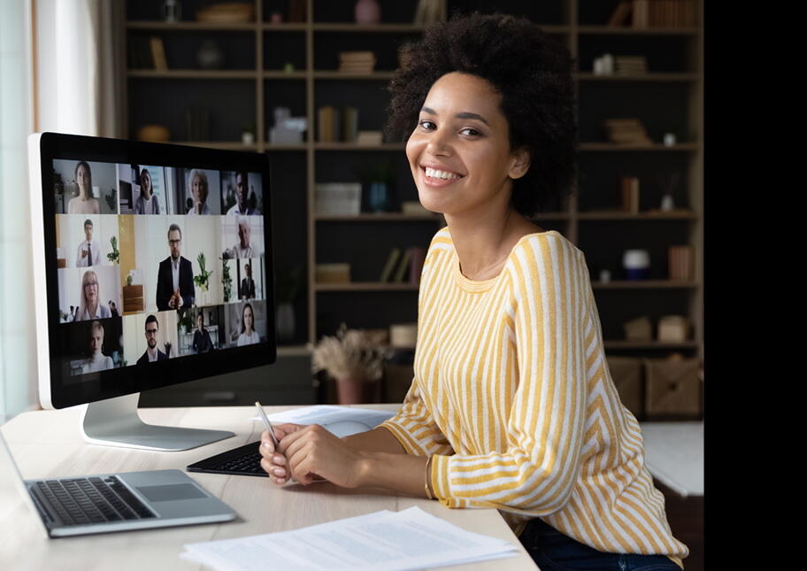 Woman sitting at a desk with a video meeting on the computer